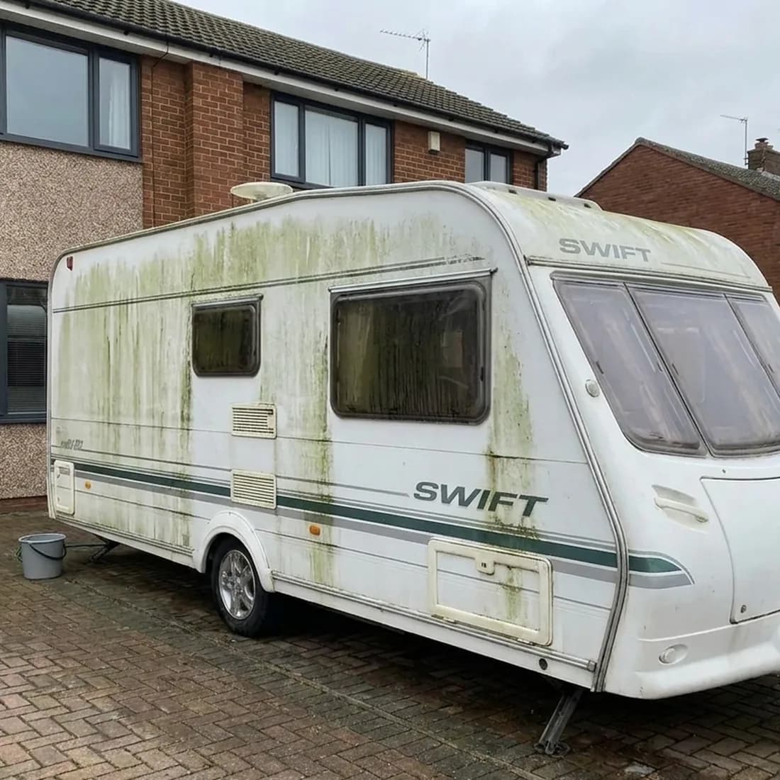Neglected caravan, green and stained, before valeting