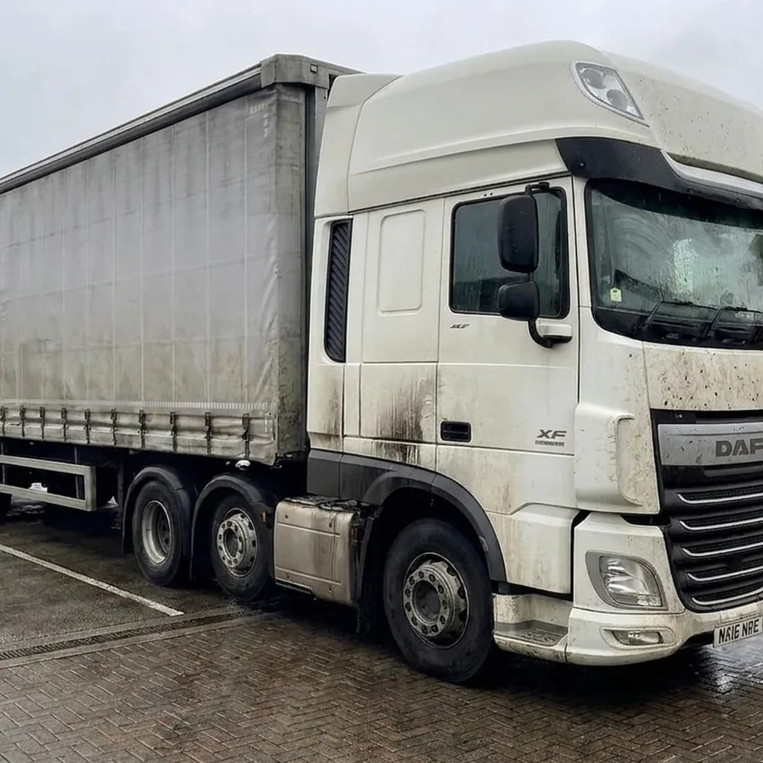Road-grimed truck with old decals before washing