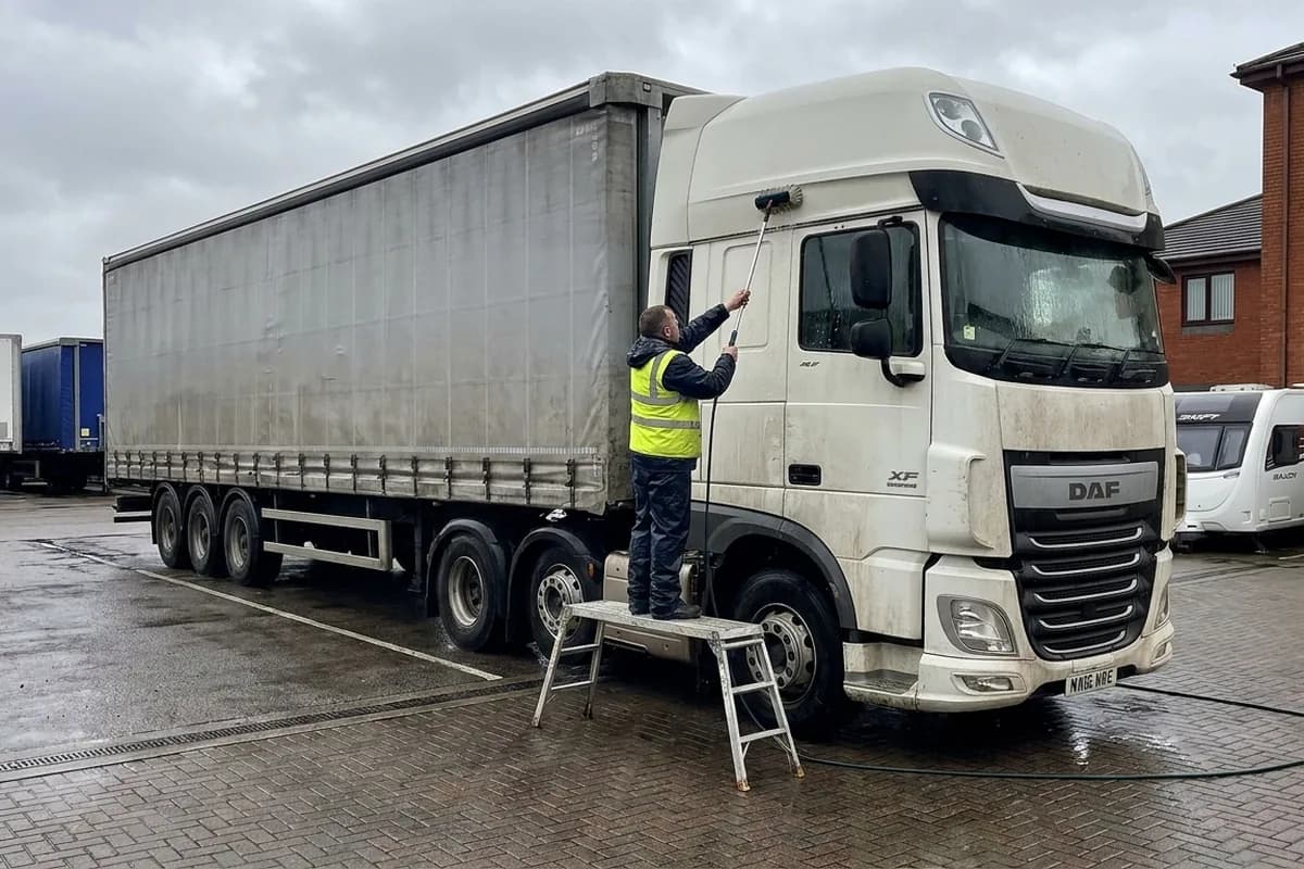 Truck cab and trailer being washed